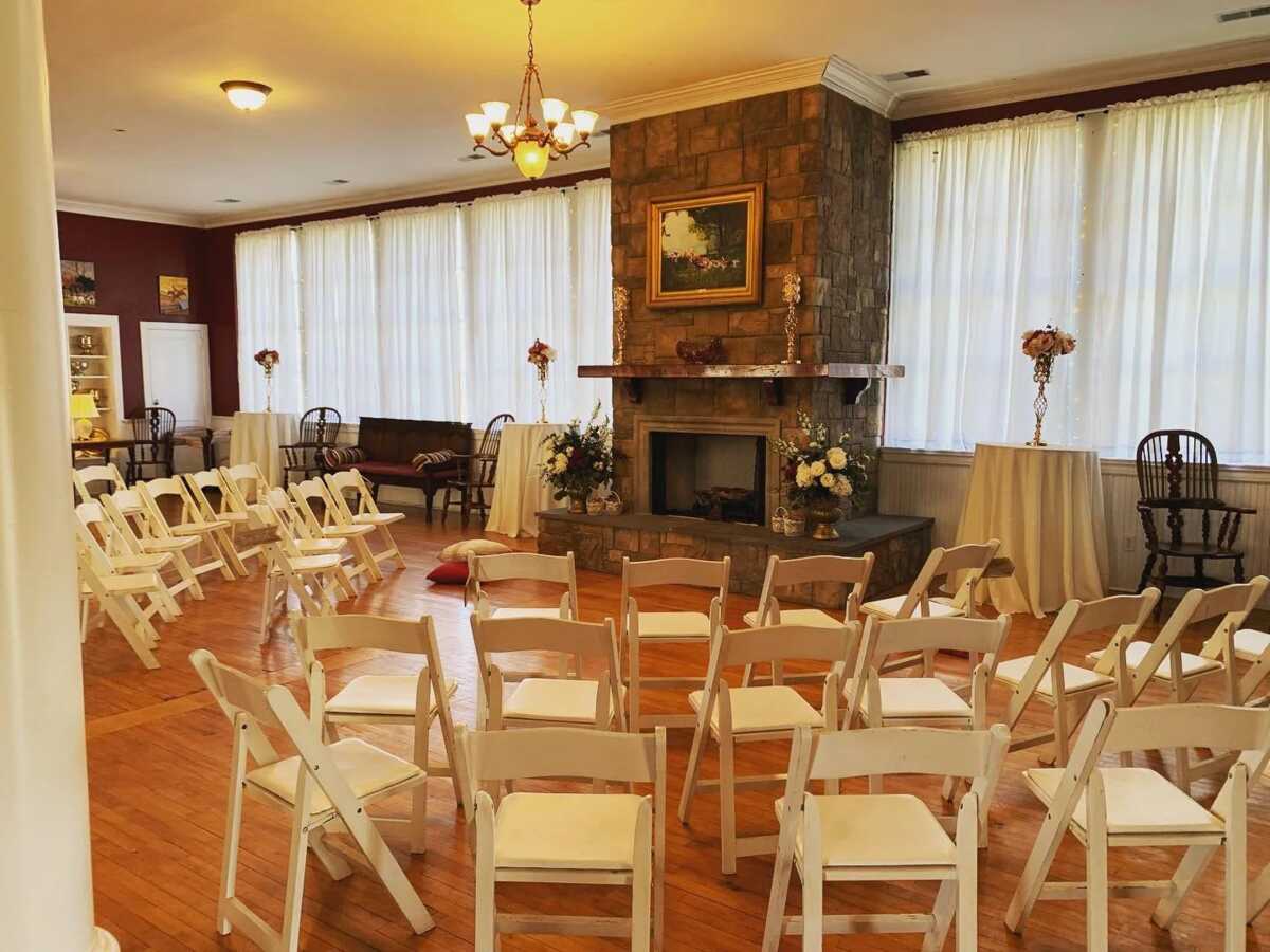 Interior of meeting venue for 2027, room with fireplace and chairs,